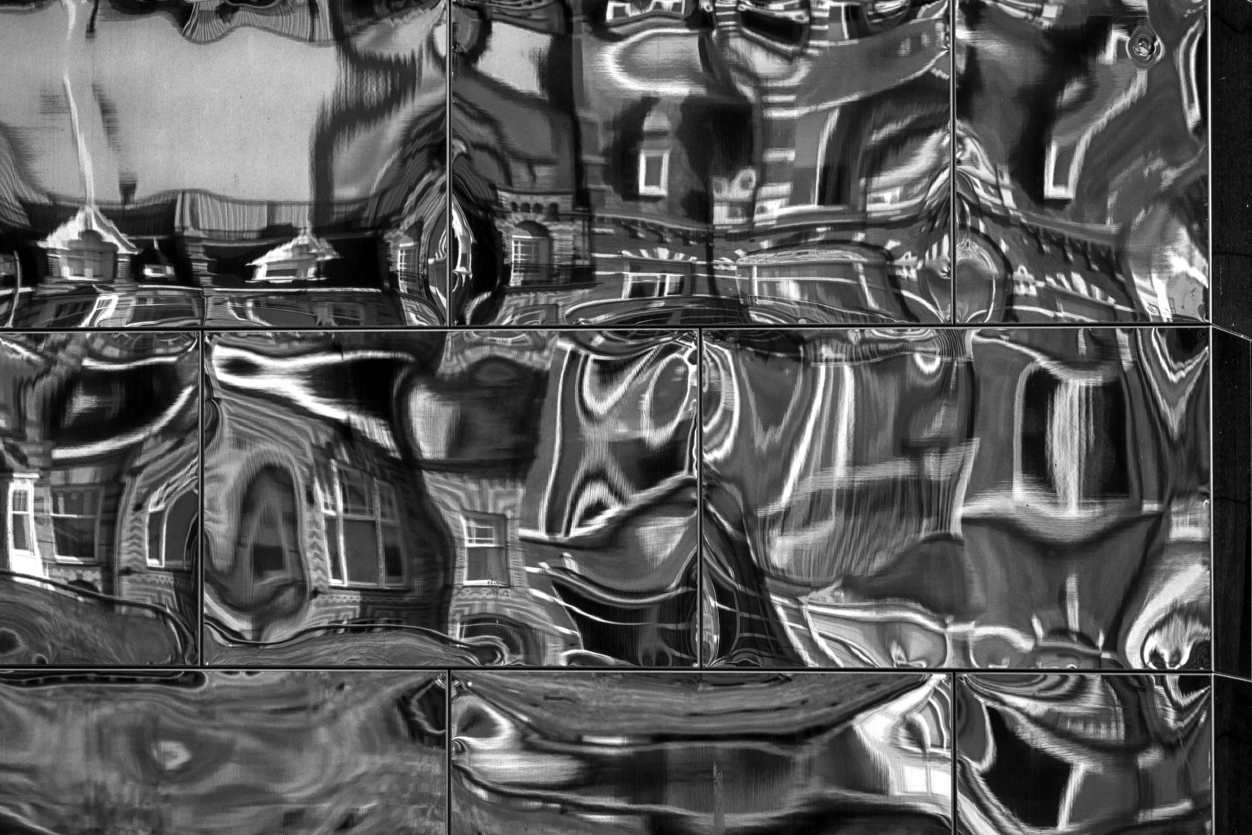 building reflected in mirrored panel