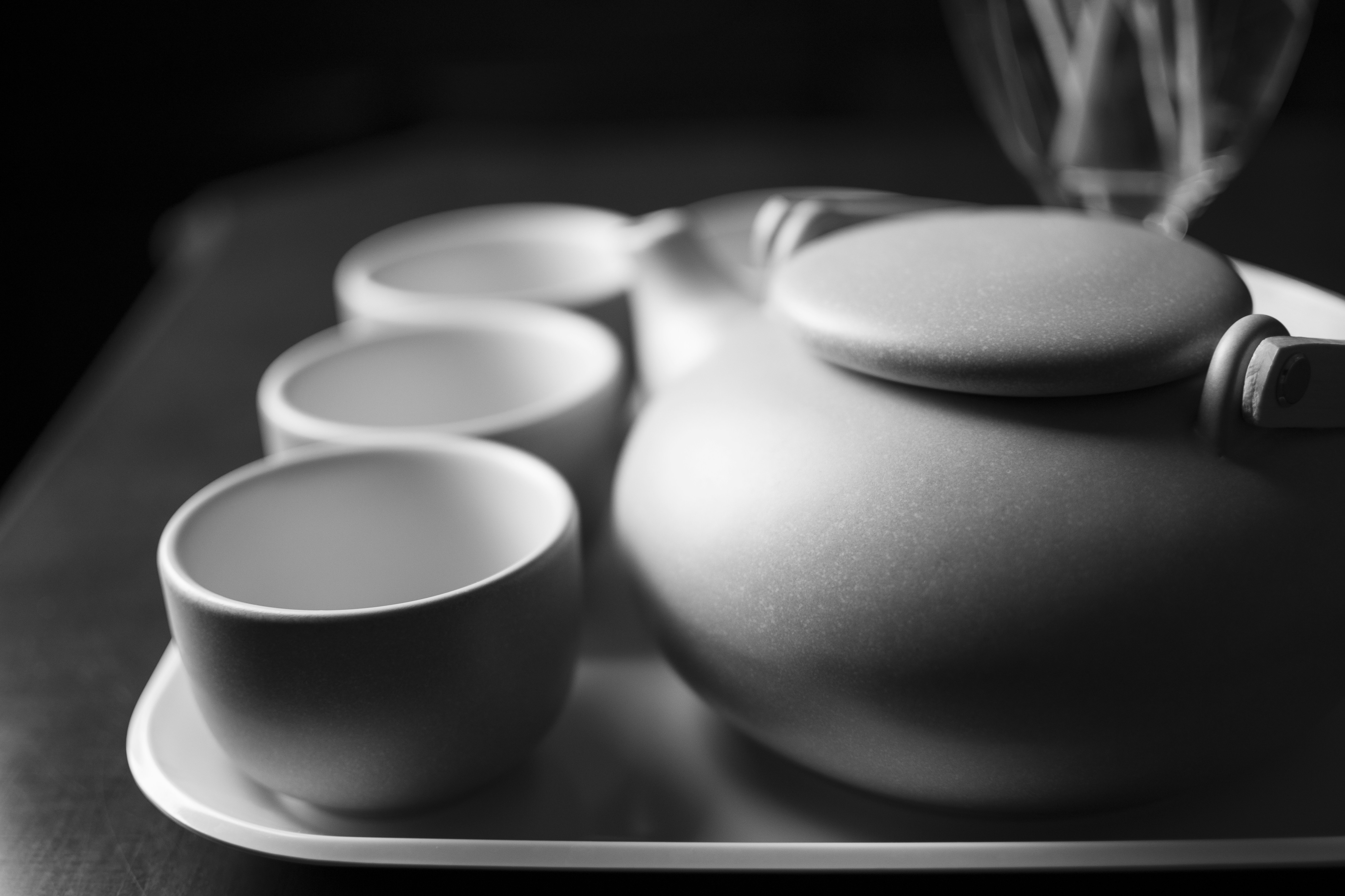 White teapot and tea cups on tray